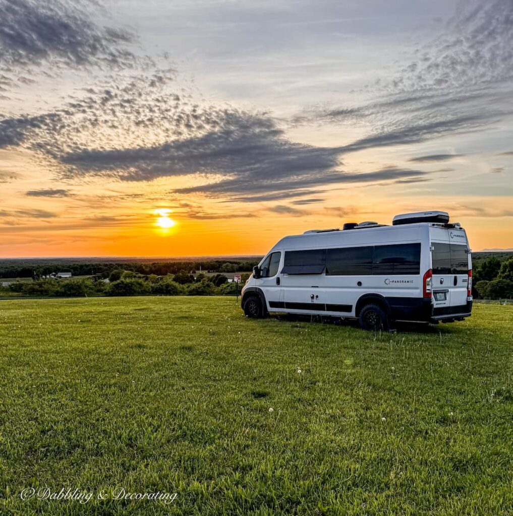 White Panoramic Van RV on hilltop at Vignoble de l'Orpailleur in Dunham, Quebec during sunset.