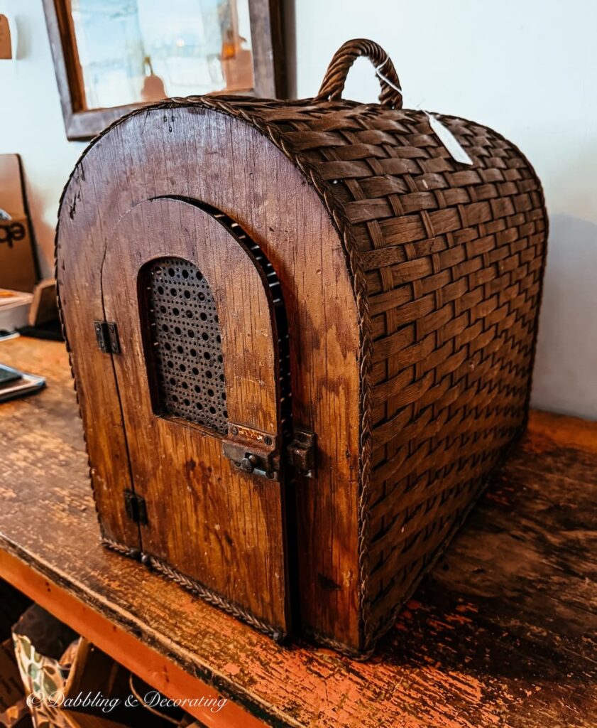 Antique wicker pet carrier on counter at Open House Portland in Maine.