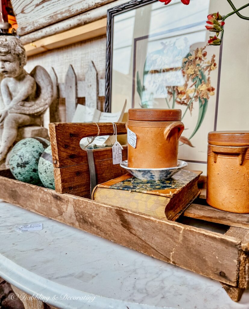 Terracotta pots mixed with turquoise textures and patina in vintage booth display.