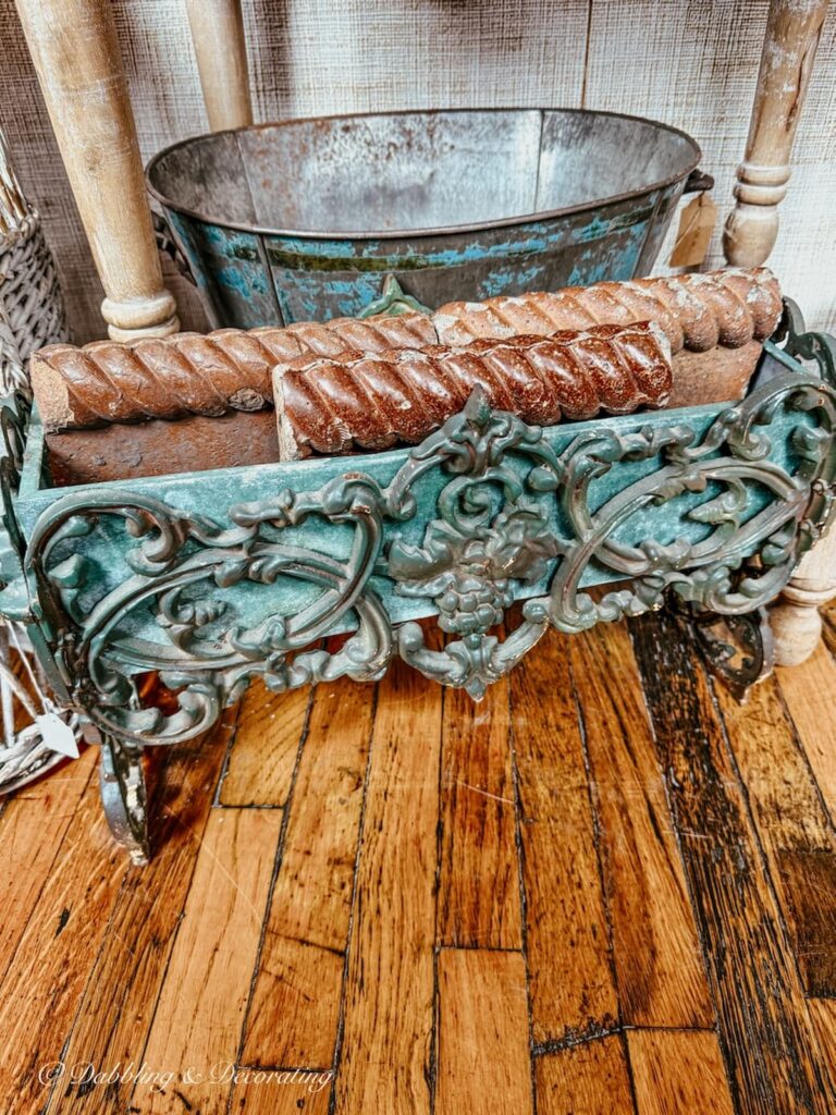 Patina turquoise summer outdoor planter with terracotta tiles in vintage urban antique store in Portland.