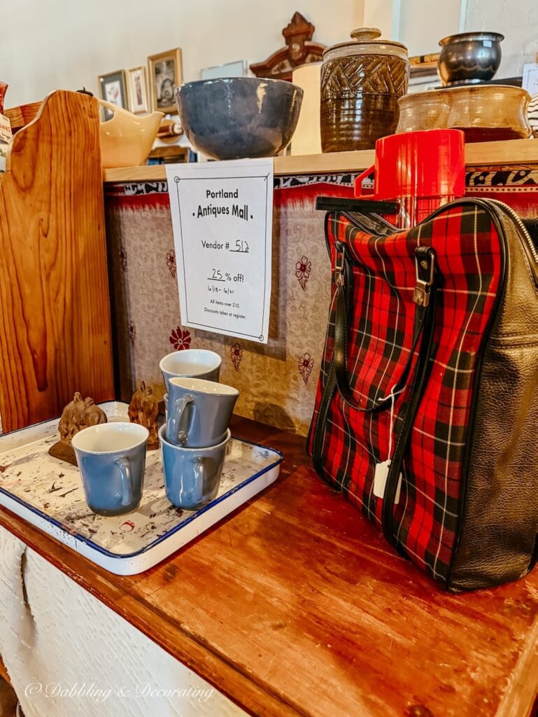 Vintage plaid red and black bowling back used as a picnic bag today in vintage urban style antique store.