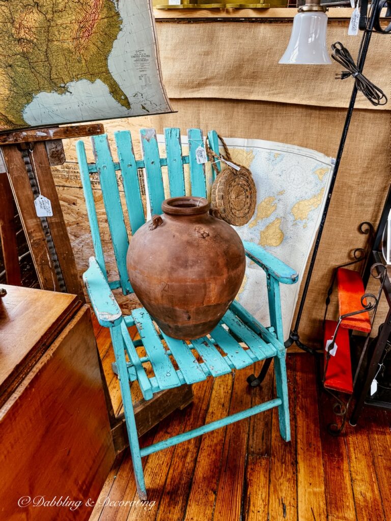 turquoise outdoor wooden chair with terracotta pot in vintage booth display