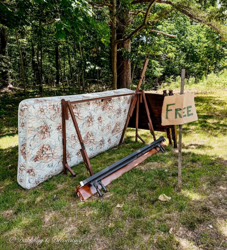 Old bed, mattress, and frame with Free sign on side of road after cleaning out my parents' attic.