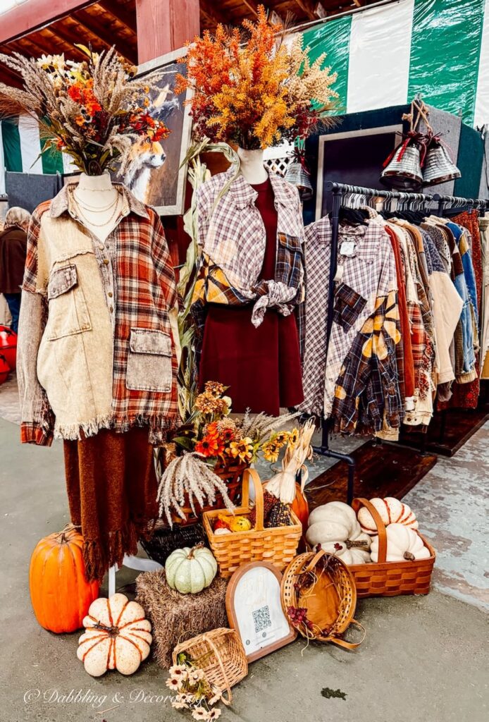 Fall vintage booth display with mannequin dressed as a scarecrow with foraged bouquet, baskets of pumpkins drawing shoppers into this vintage clothing booth at Vintage Market Days Vermont.