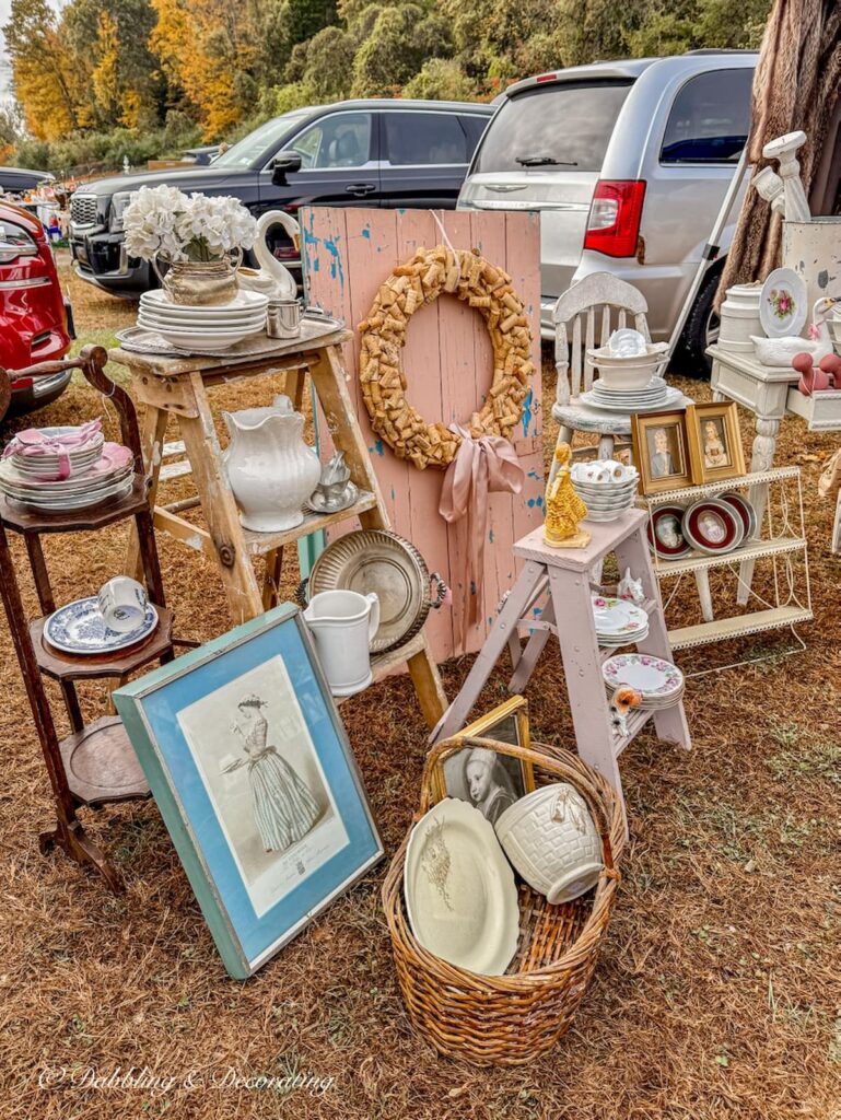 Fall vintage booth displays with soft mauve and blue colors at the Elephant's Trunk Flea Market. Ironstone, transferware, cork wreath and so much more.