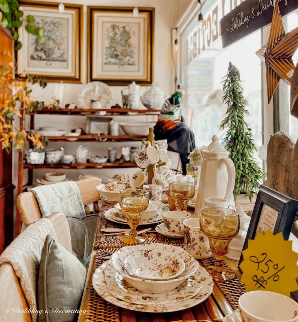 Vintage booth table display with Johnson Brother's Autumn Delight dishes and amber glassware styled for fall.
