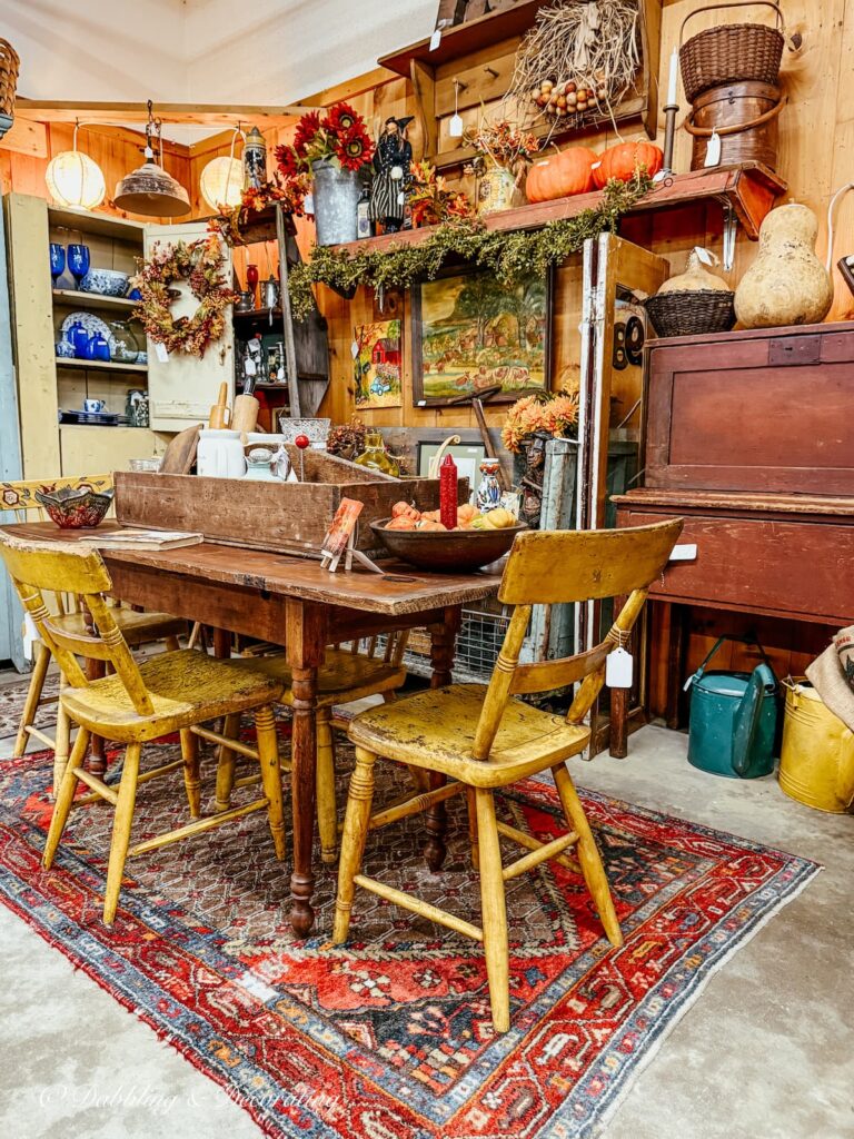 Fall vintage booth packed with antiques along with pumpkins, gourds, fall wreaths and beautiful styling and colors.