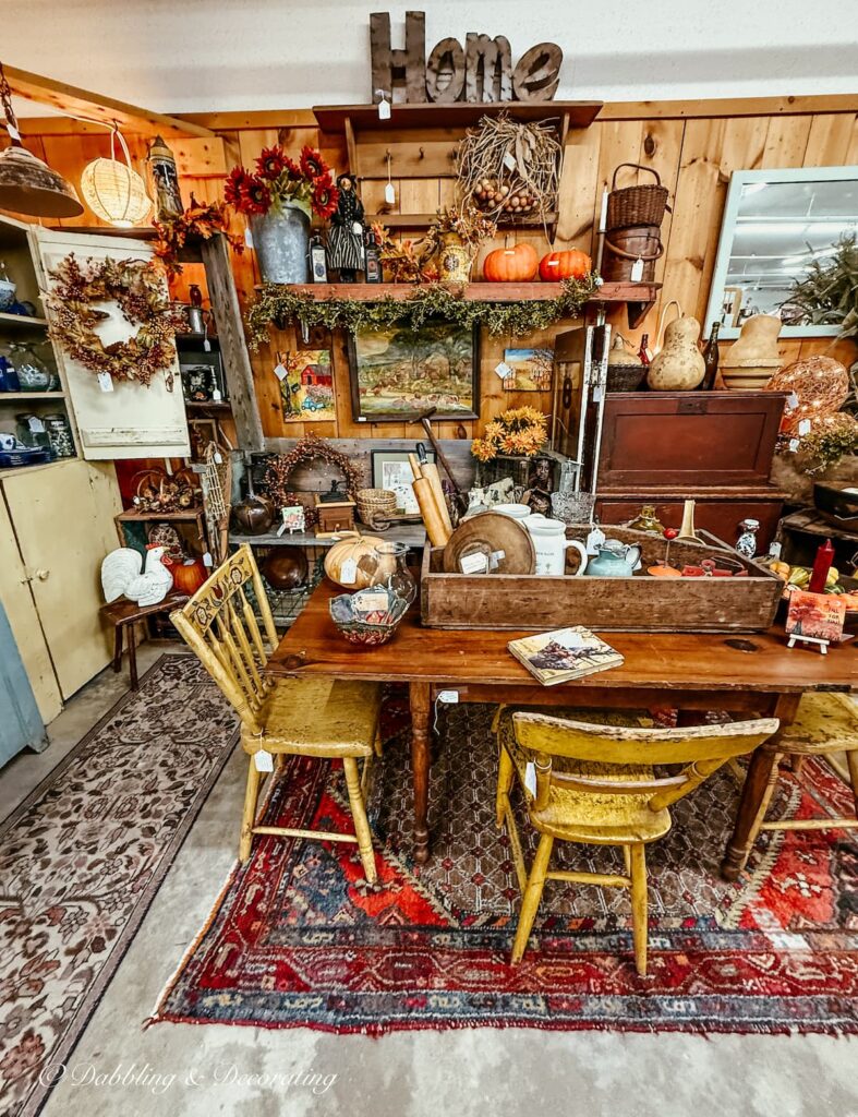 Fall vintage booth packed with antiques along with pumpkins, gourds, fall wreaths and beautiful styling and colors.
