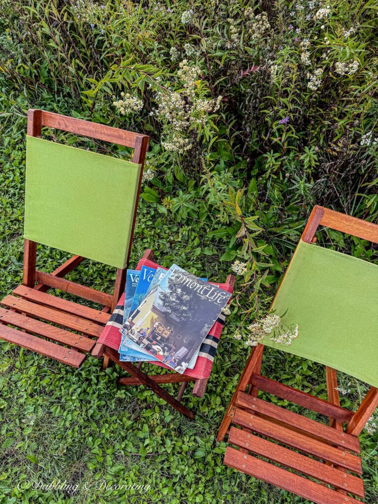 Two retro camp chairs and a little red canvas stool with Vintage Vermont Life Magazines.