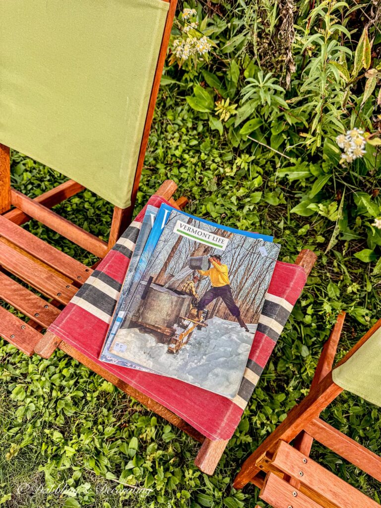 Vintage Life Magazines gathered on canvas red retro camp stool at Smuggler Notch campground in Vermont during the Fall.