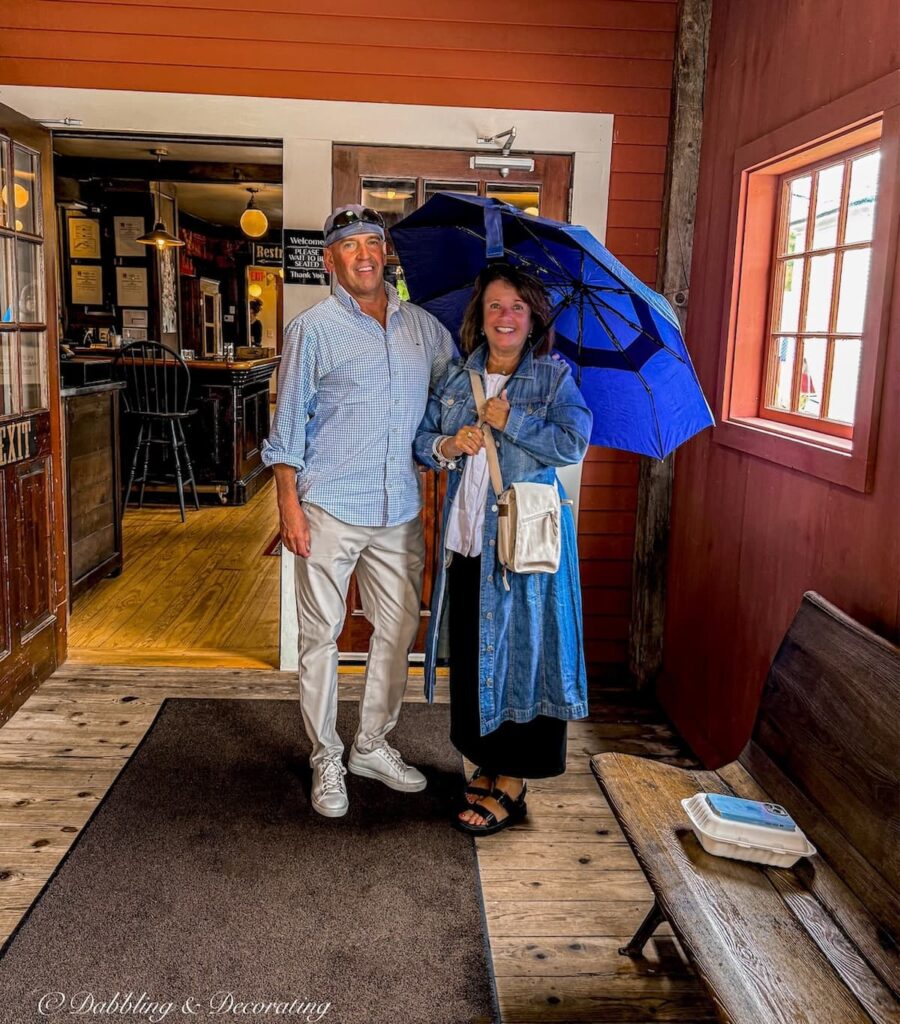 Ann and Steve with Umbrella outside Mildred's Table at The Vermont Country Store.