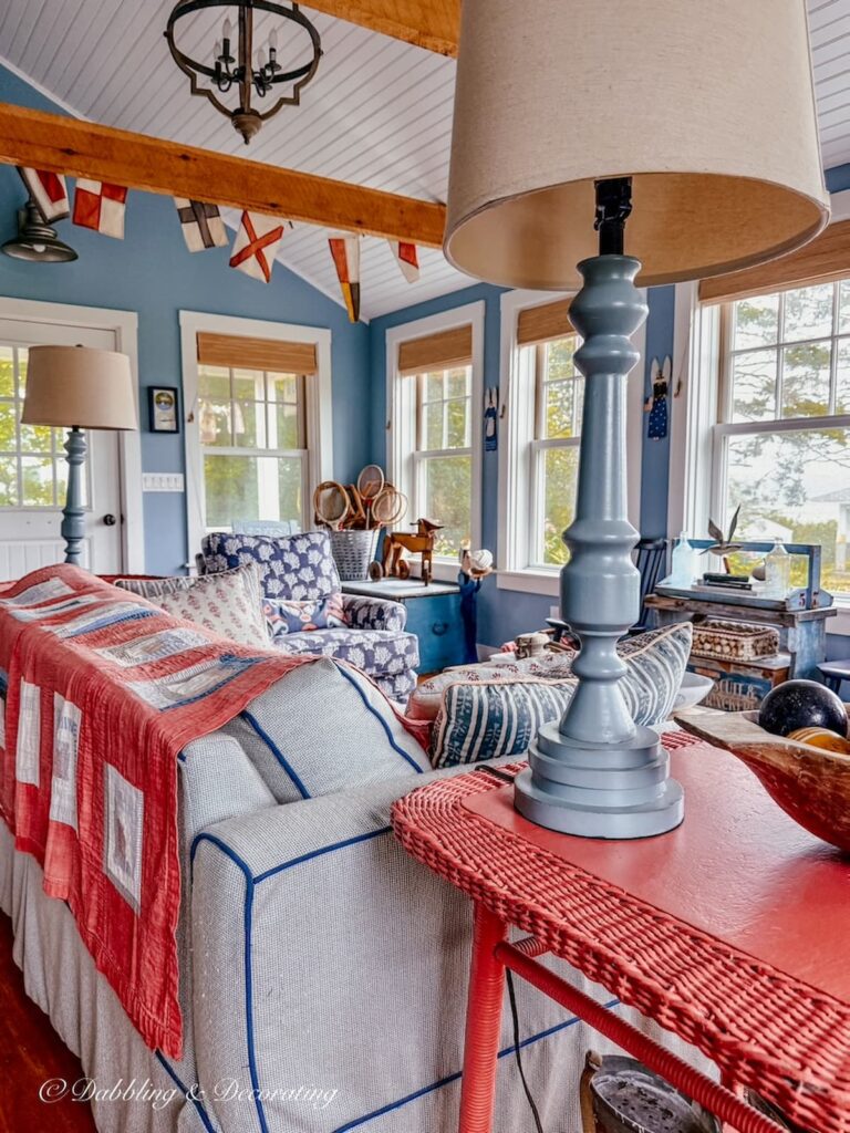 Inside a colorful coastal beach guest cottage styled with vintage charm in blues and salmon colors.