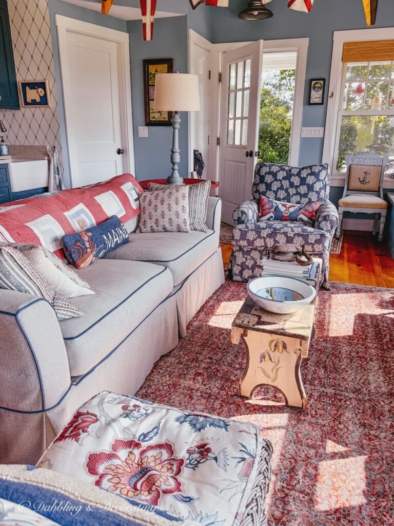 Inside a colorful vintage inspired coastal Maine guest cottage with door open upon leaving.
