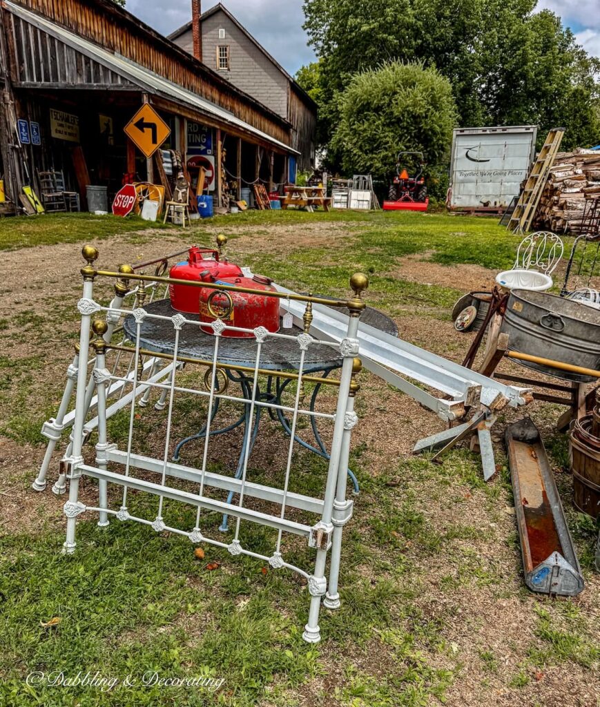 Two white wrought iron and brass twin beds at outside at Elmer's Barn in Maine.