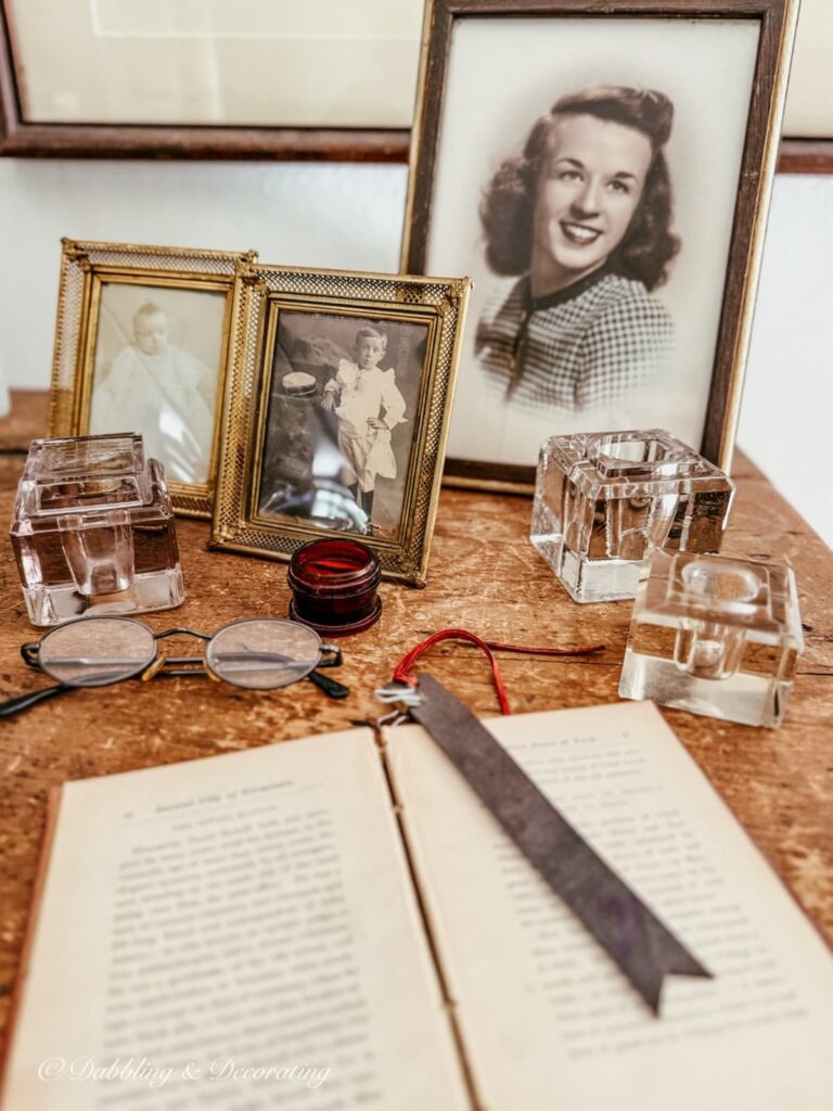 Collection of vintage ink wells on an antique inspired desktop.