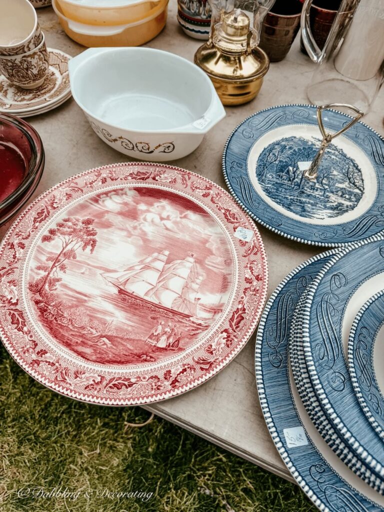 red and white and blue white Johnson Brothers transferware dishes on flea market table in the Adirondacks.
