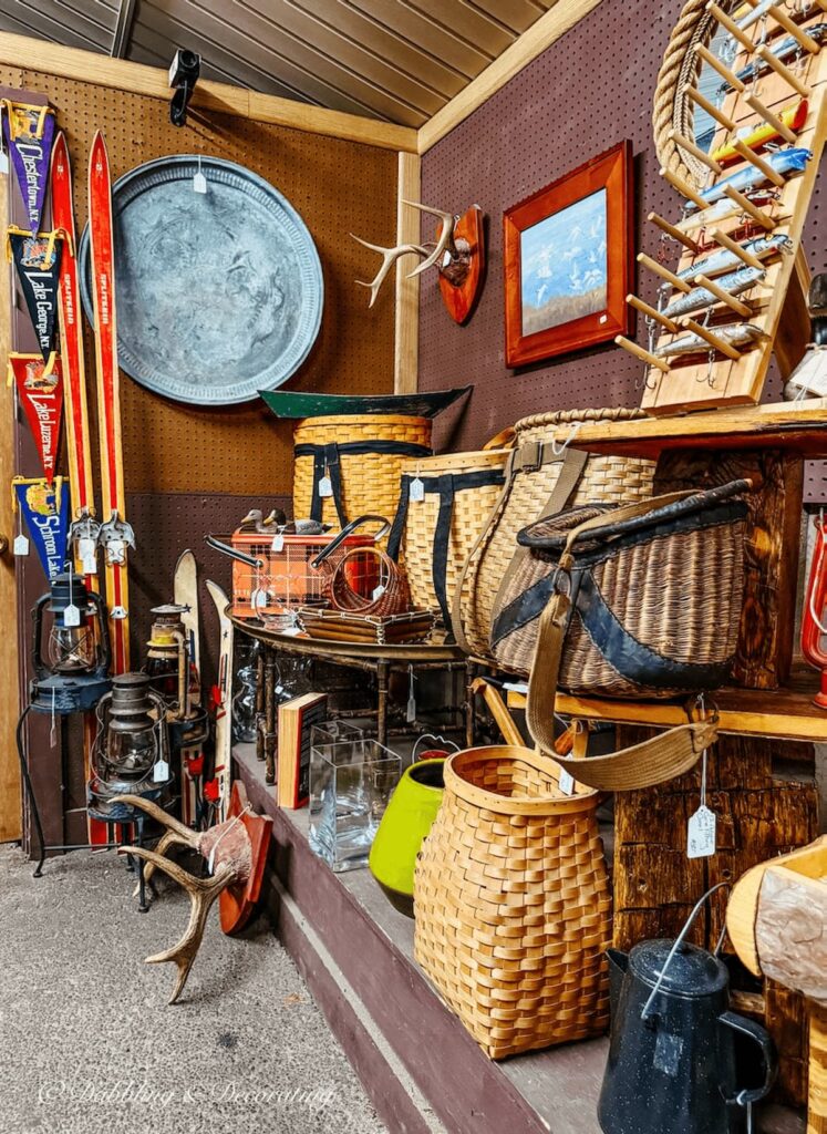 Adirondack lodge styled decor like skis, camping baskets, and more at Hay Fields Antique store in the Adirondacks.