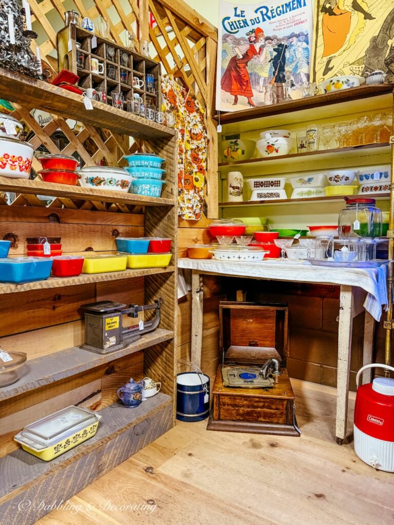 Small antique booth at Hay Fields Antique Store filled with collections of colorful Pyrex.