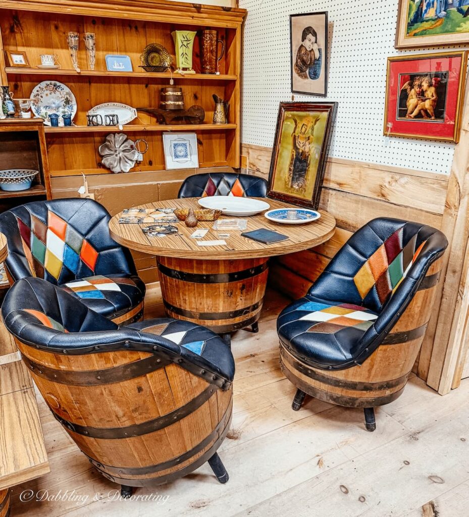 Adirondack style barrel table with colorful leather chairs that matched inside Hay Fields Antique Store in the Adirondacks.