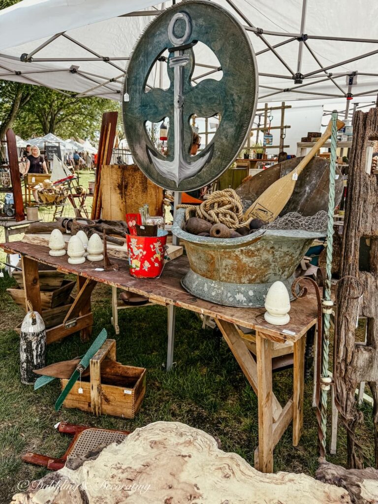Antique booth display with vintage maritime items old buckets, rope, oars and boat architecture pieces on display at Vintage Bazaar.