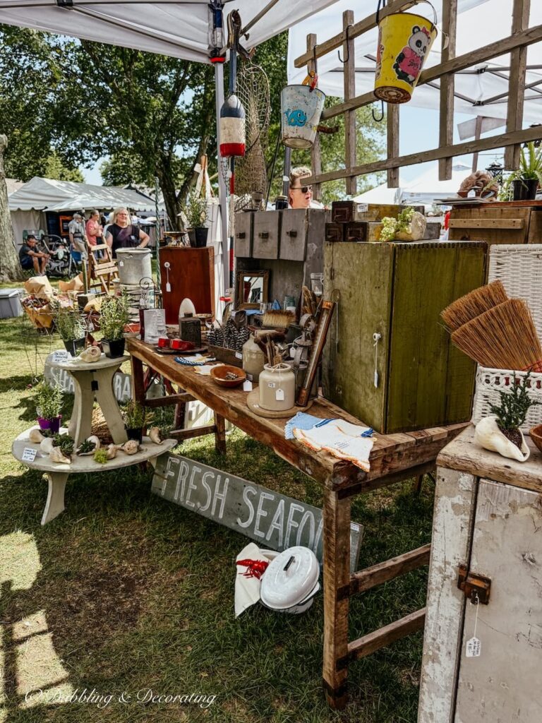 Antique booth display layered and styled beautifully outdoors with vintage coastal details at Vintage Bazaar.