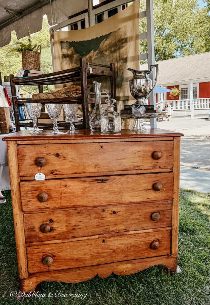 Antique wooden dresser display at Vintage Bazaar New England outdoor under tent.