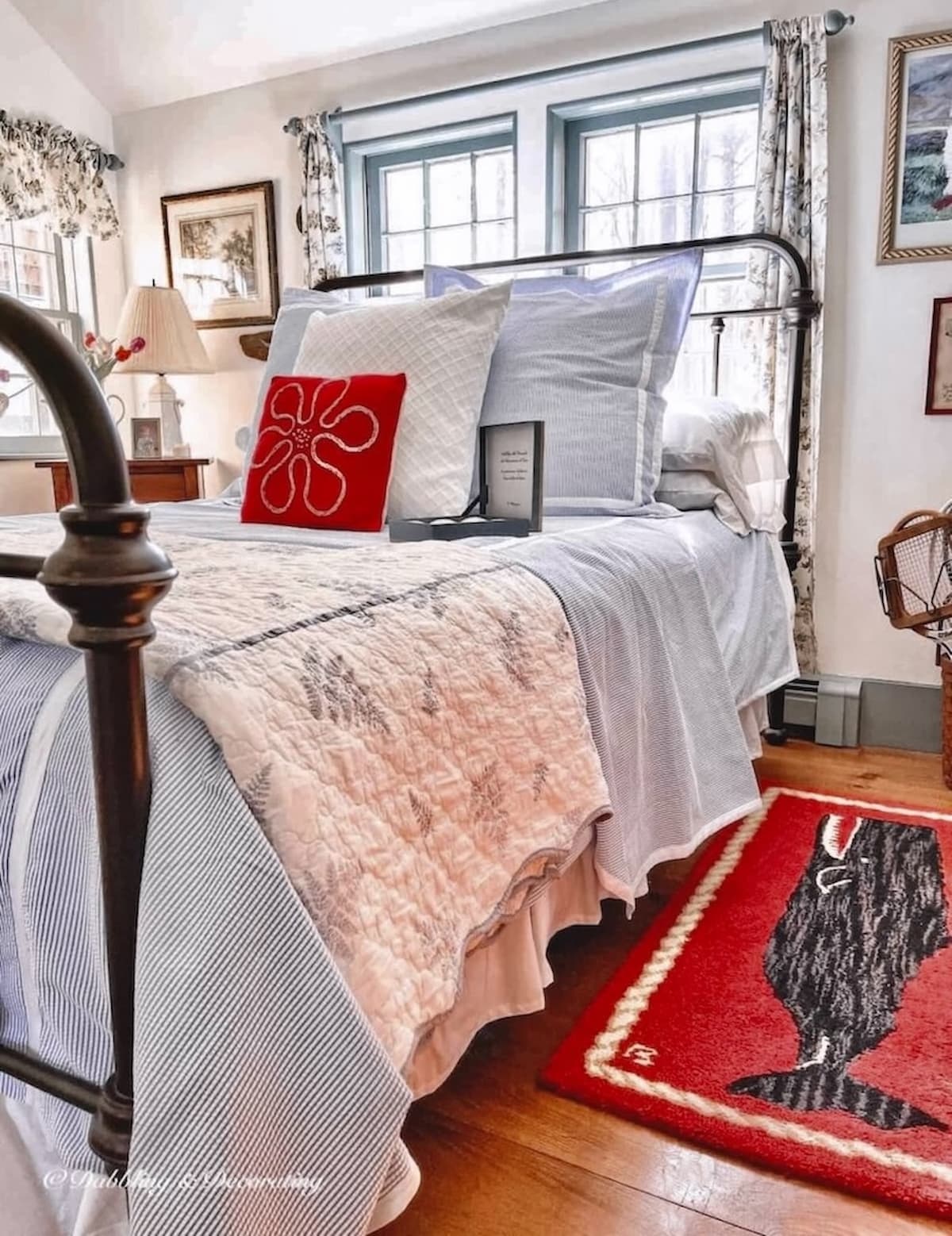 Small guest bedroom in old colonial Maine home with seersucker bedding and and red whale rug with custom blue historic paint trim and simply white walls.