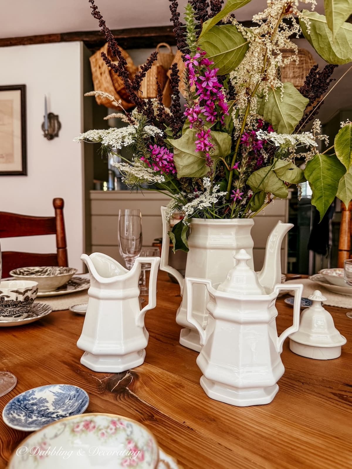 Vintage styled tablescape with summer to fall foraged flower centerpiece with family heirloom antique china place settings.