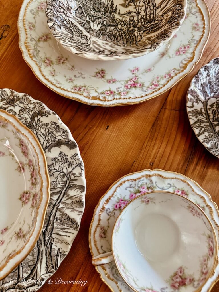 Mixed china patterns on vintage wooden table for a summer to fall tablescape.