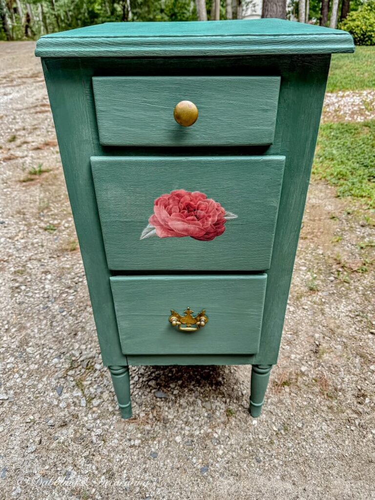 Painted Nightstand Makeover in Annie Sloane Green with red rose transfer on middle drawer.