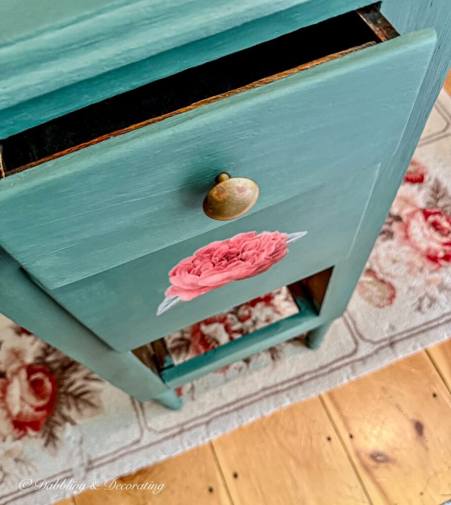 Annie Sloane painted nightstand makeover with transfer of red rose on middle drawer.