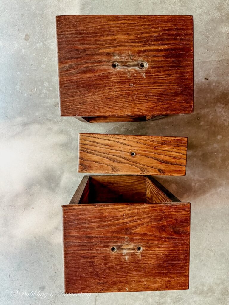 Three wooden oak drawers without hardware for nightstand painting project.