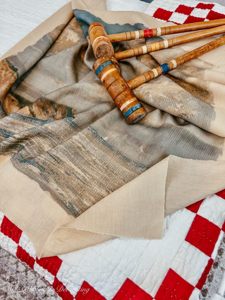 Thrifted bedroom ideas with three old croquet mallets and a vintage tapestry.