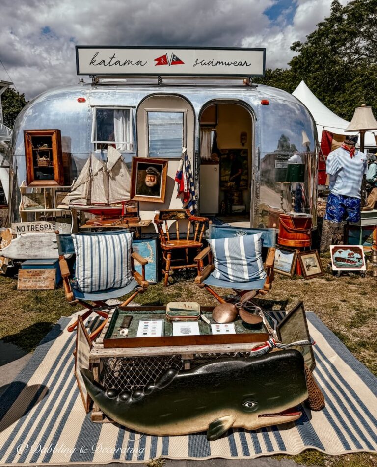 The air stream coastal inspired booth in Mystic, Connecticut at Vintage Bazaar New England with nautical chairs, sailboats, rugs, whale art work and swimsuit line.