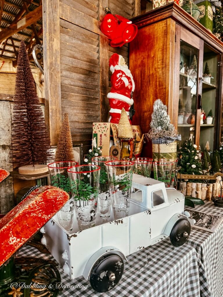 Vintage white toy truck with Christmas glassware in Vintage Christmas Booth Display at the Country Living Fair.