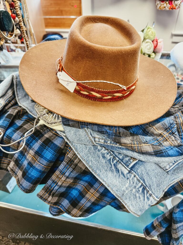 Thrifted blue plaid shirt, denim jacket, and brown felt hat for a fall scarecrow.