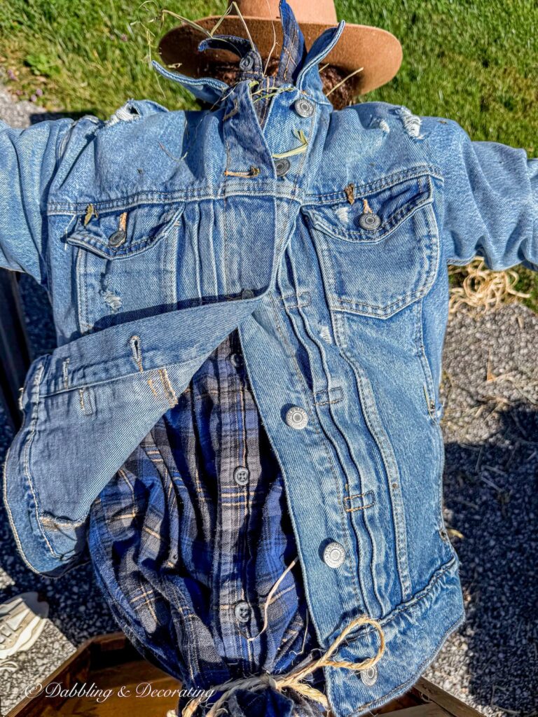 Fall scarecrow laid out and getting layers of plaid and denim and stuffed with straw.