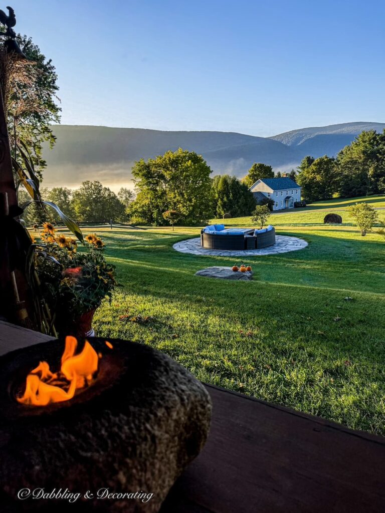 Mountain Views at early dawn with fire pit and fire burning on porch on a colorful fall porch.