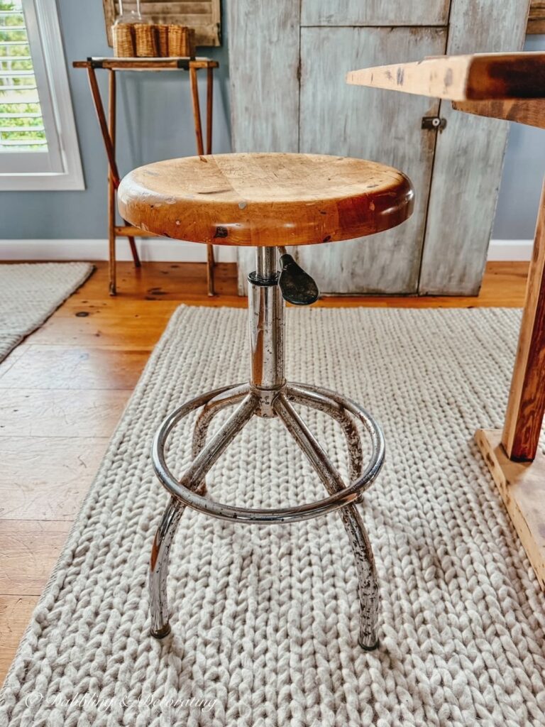 Rusty antique drafting stool in vintage inspired kitchen scullery.