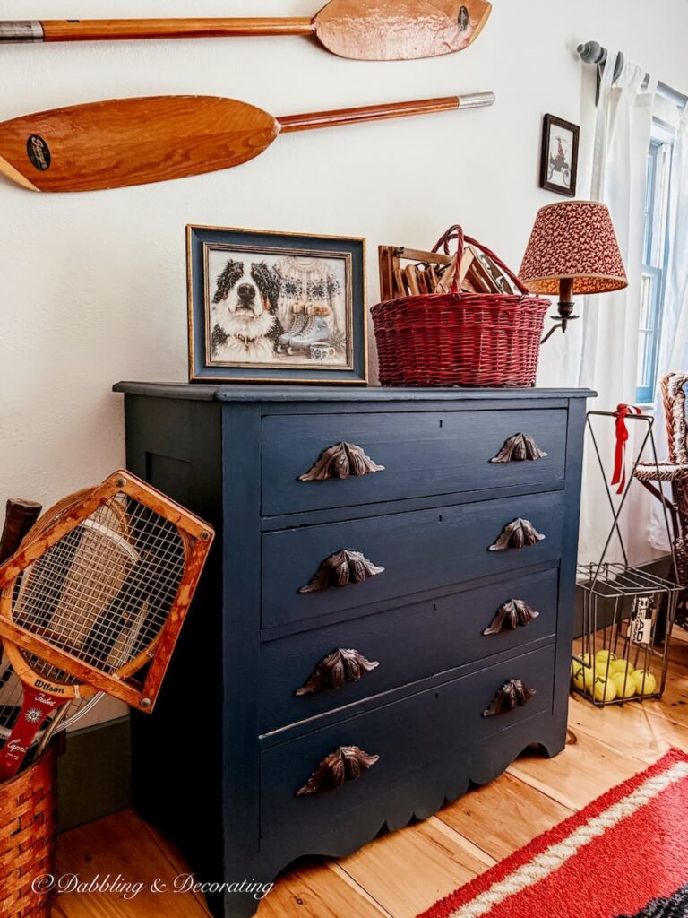 Bedroom dresser with The Dabbling & Decorating Winter Collection portrait framed on dresser.