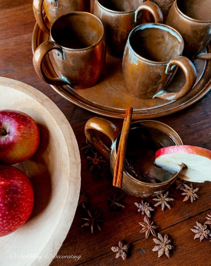 Fall vignette with vintage copper mugs, apples spices for fall.