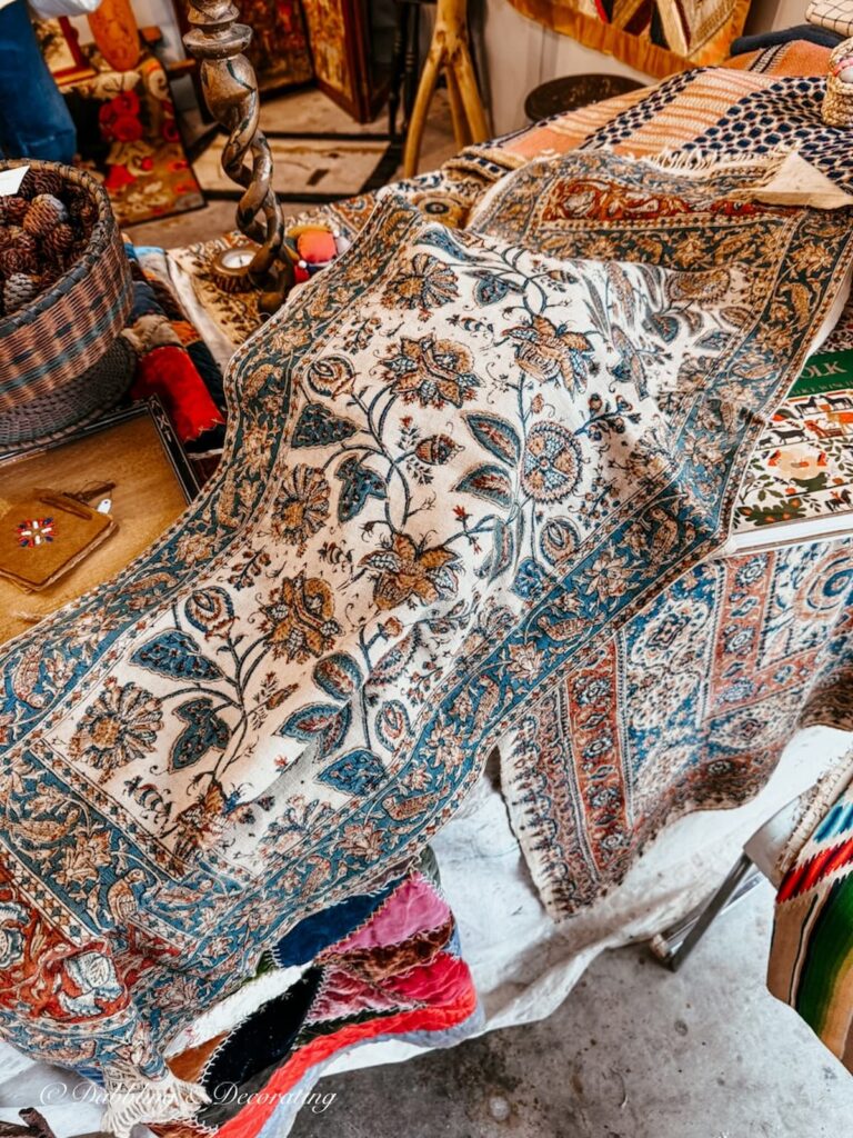Antique Iranian textile in browns and blues inside High-End Antique Booths at the Taconic Antiques Fair in Chatham, NY.