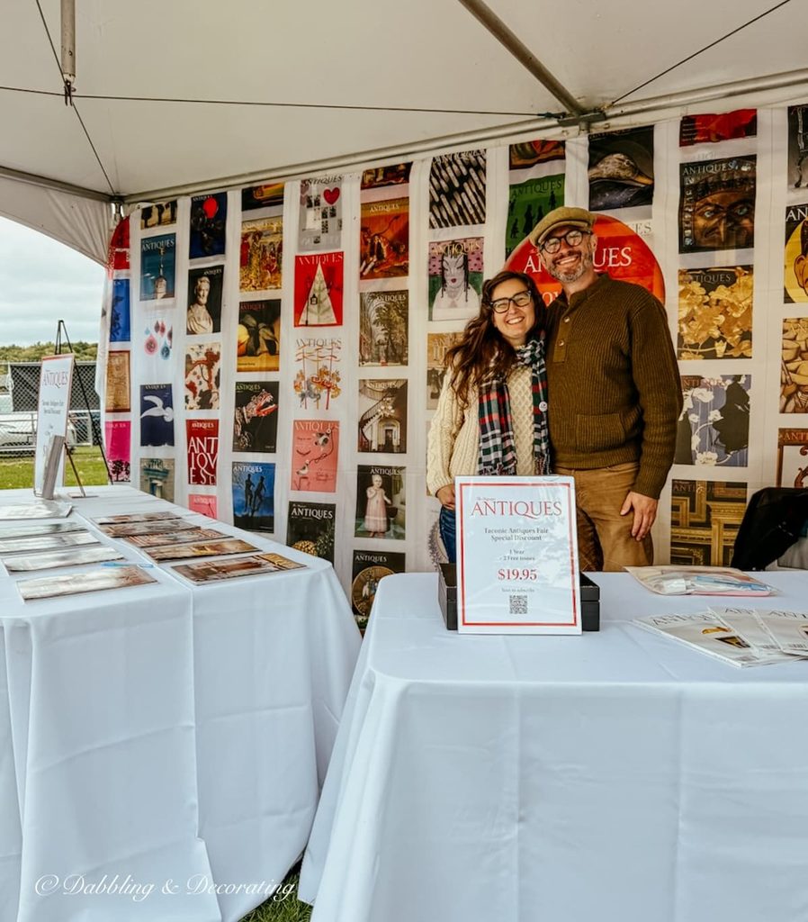 Man and woman at the  Antiques magazine booth at the Taconic Antique Fair in Chatham, NY.