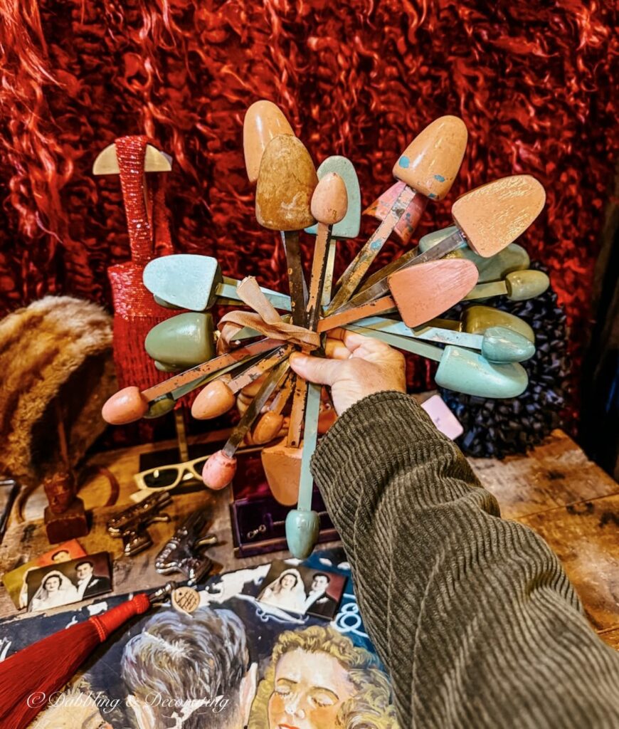 Antique shoe stretchers in a bundled arrangement in hand at an antique fair in New York.