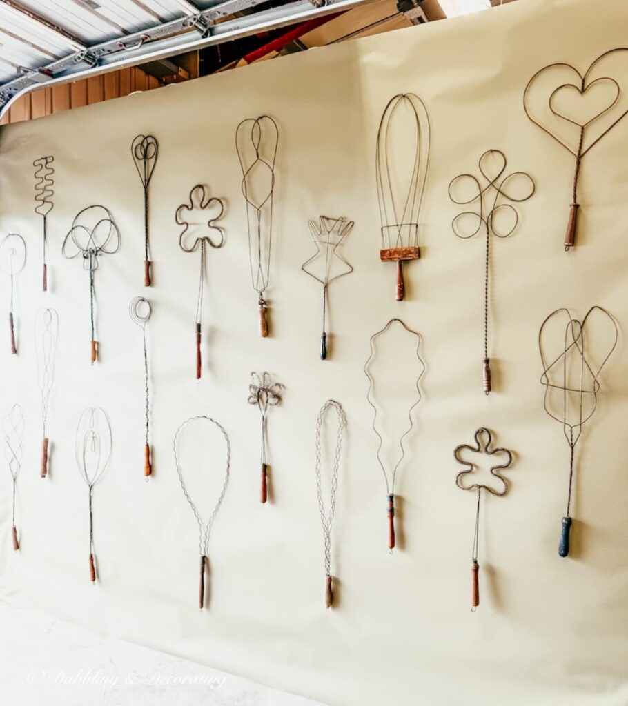 Wall collection of rug antique rug beaters displayed in such a creative eclectic style at Taconic Antiques Fair.