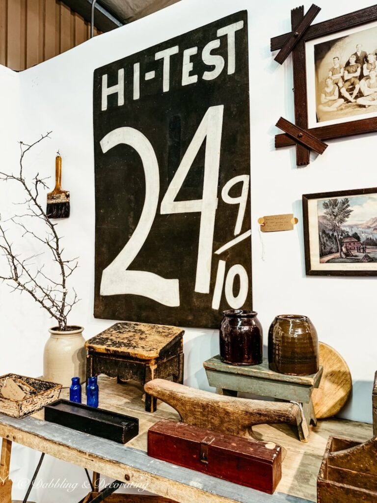 Antique booth display with high end antique display at the Taconic Antiques Fair with large Hi-Test 24 9/10 sign.