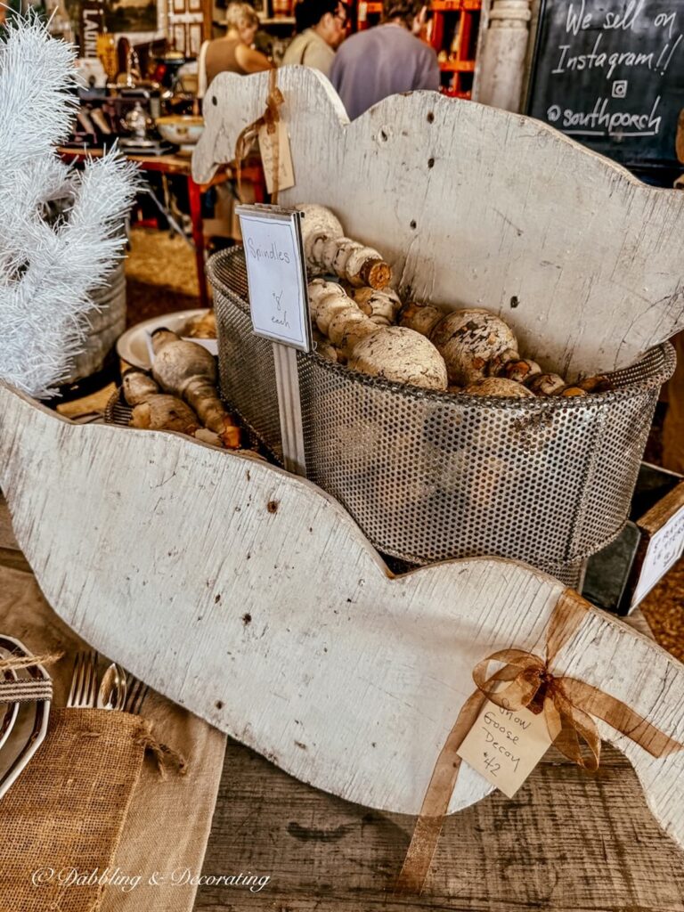 Two wooden snow geese at a vintage booth at Country Living Fair.