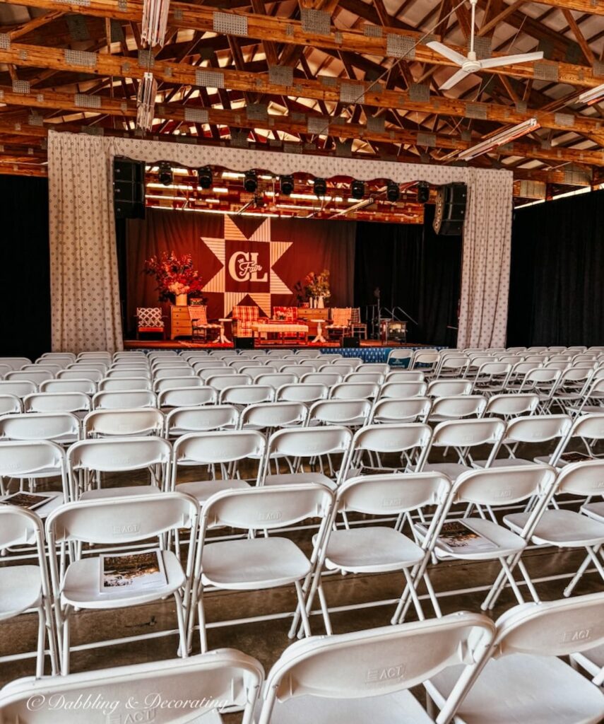 Country Living Fair speaker stage with chairs and living room set up on stage.