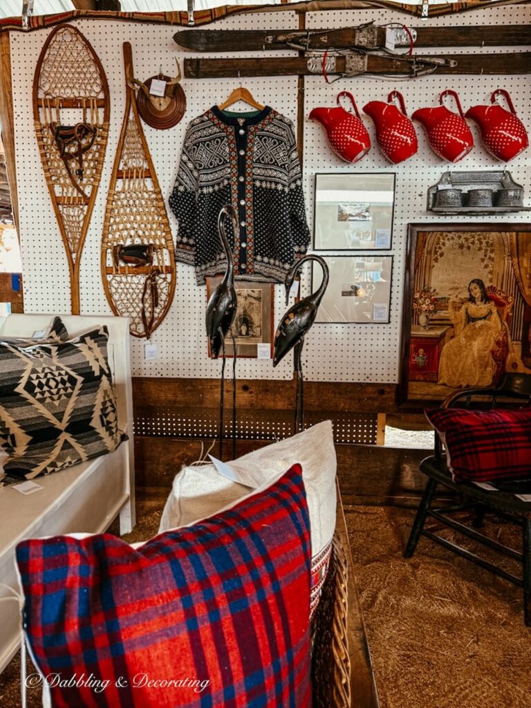 Vintage snowshoes, sweater, red pitchers and more displayed in a vintage booth at the Country Living Fair.