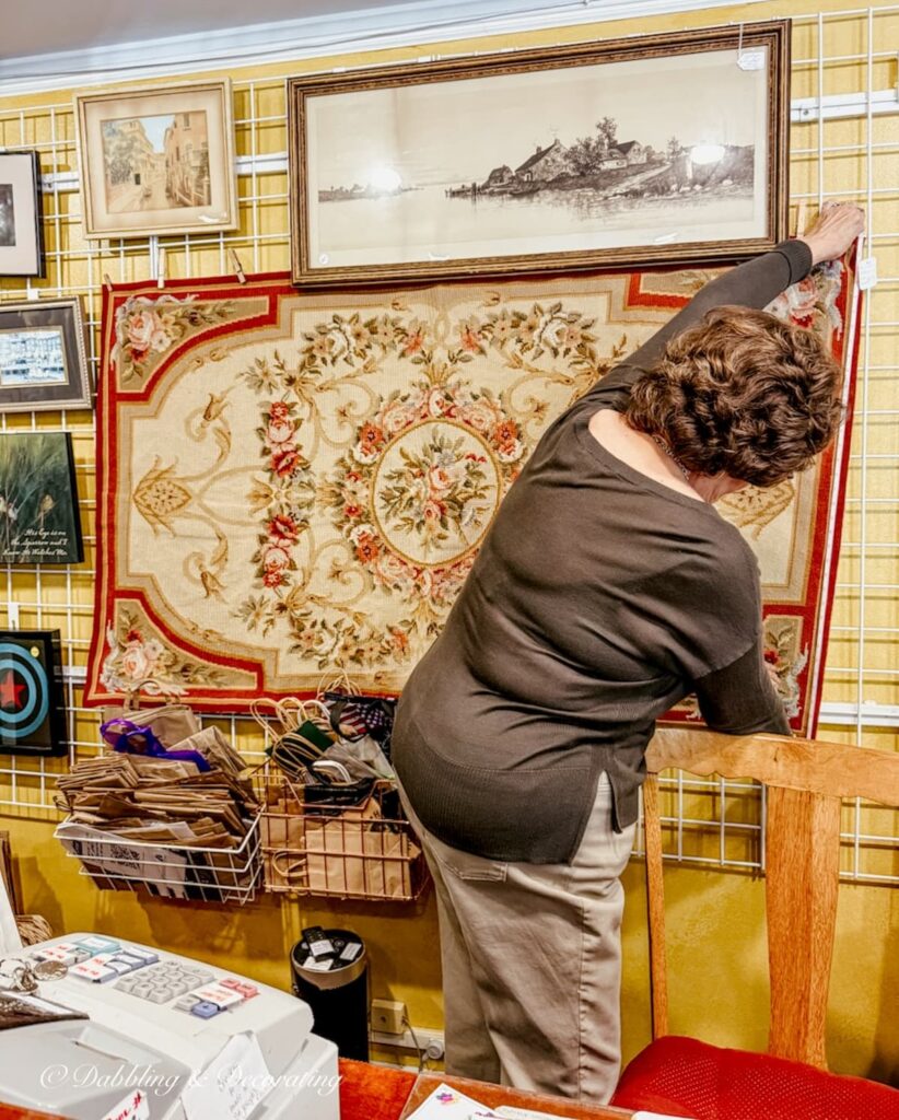 Needlepoint rug hanging on the wall at Thrift Store in MillBrook, NY.